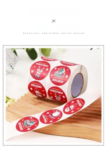 Close-up of Merry Christmas sticker rolls with Santa and snowman on a wooden display
