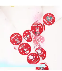 Detail of Christmas snowman and Santa Claus gift labels on red round sealing stickers