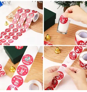 Detailed view of Merry Christmas snowman gift labels on a roll for holiday packaging decoration