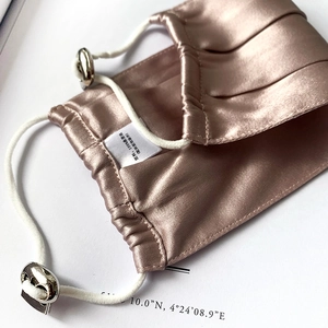 Detail of pure mulberry silk face mask with adjustable elastic ear loops and metal buckle