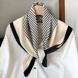 Elegant black and white striped faux silk scarf styled on a classic white shirt