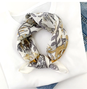 Close-up of silk scarf featuring vintage hand-painted bird and floral patterns on white tee