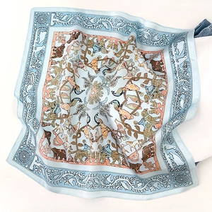 Detail of silk scarf with vintage animal and floral print showing smooth fabric folds