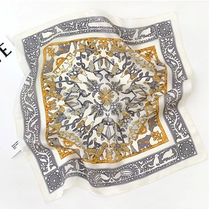 Detailed view of silk scarf with vintage animal floral pattern on white background