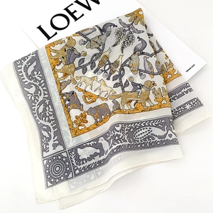 Detail of silk scarf showing vintage animal illustrations and hand-rolled edges