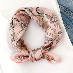 Elegant silk scarf with pink vintage floral and peacock prints on a denim background