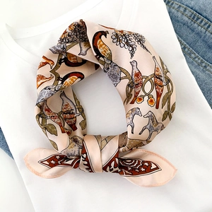 Elegant silk scarf with vintage bird and floral print styled on a white t-shirt