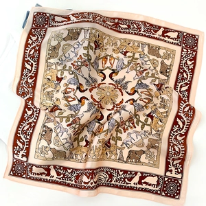 Macro detail of silk scarf featuring vintage animal prints and elegant floral motifs
