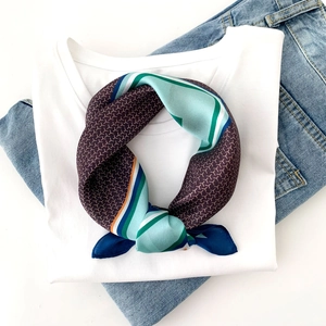 Detail of color-block silk scarf with geometric Y-pattern on a white t-shirt