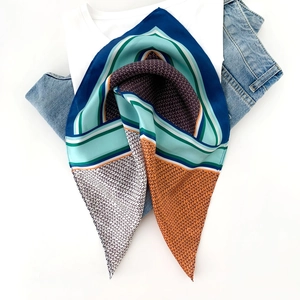 Detail of silk scarf featuring color-block geometric patterns and Y-shape texture overlay