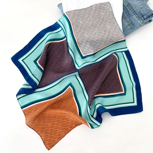 Silk square scarf with geometric print and bold color blocking on white background