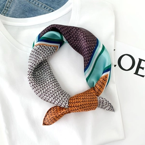 Silk neck scarf with geometric patterns and color blocks on a white shirt collar