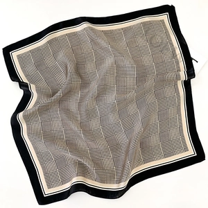 Détail d'un foulard en soie avec motif pied-de-poule et textures géométriques élégantes