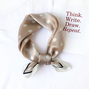 Champagne silk scarf with white polka dots on white t-shirt background with card decoration