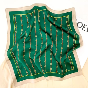 Detail of silk square scarf featuring vintage emerald green and gold chain patterns