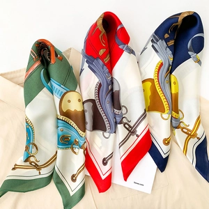 Detailed view of three vintage equestrian print silk scarves in green, red, and blue tones