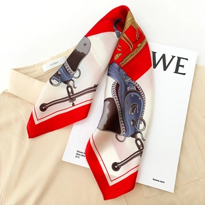 Detail of silk scarf featuring classic equestrian motifs and horse patterns