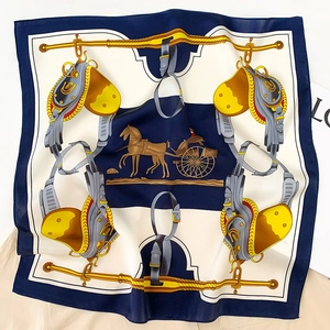 Detailed pattern of a silk square scarf showing classic equestrian horse and carriage motif