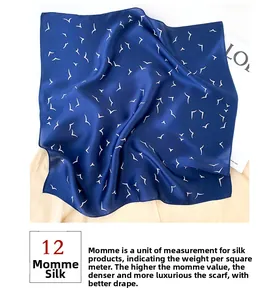 Macro detail of 12 momme mulberry silk scarf with white seagull print on navy blue fabric