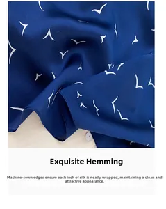 Close-up of premium silk scarf featuring elegant seagull pattern and fine machine-rolled hem