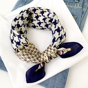 Classic houndstooth silk scarf with chain pattern on white t-shirt and jeans