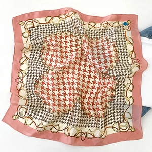 Detail of 100% mulberry silk scarf with pink borders and elegant houndstooth pattern