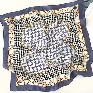 Detail of 100% silk square scarf with houndstooth pattern and blue chain print borders