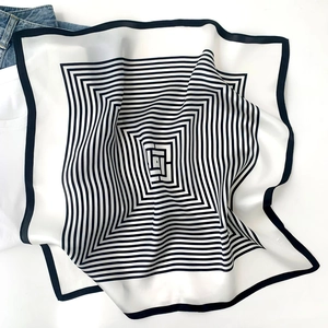 Detail of premium houndstooth silk scarf with minimalist black and white geometric pattern