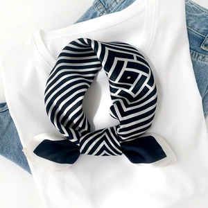 Close-up of a 100% mulberry silk scarf with black and white geometric houndstooth pattern