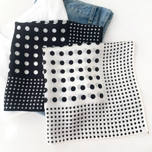 Flat lay of polka dot mulberry silk scarves with white tee and blue jeans for styling