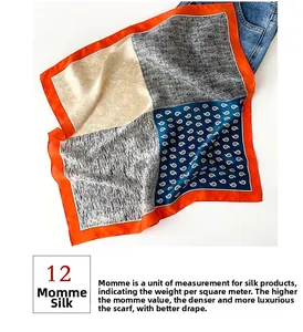 Detail of 12 momme silk square scarf with colorful paisley patterns and orange border