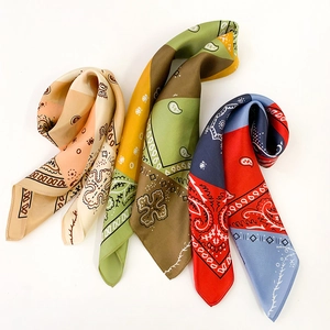 Detailed close-up of three colorful paisley silk scarves with geometric ethnic patterns