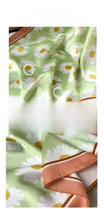 Close-up of light green daisy silk scarf featuring premium stitching and soft texture
