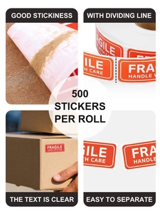 Detail of red fragile warning labels showing high adhesive backing and easy-tear perforations