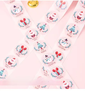 Detail showing rolls of Christmas stickers with cartoon snowmen and holiday patterns