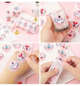 Close-up of pink Merry Christmas stickers showing application on a cup and roll detail