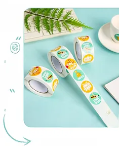 Macro view of colorful reward stickers for kids with cartoon icons and phrases on a roll