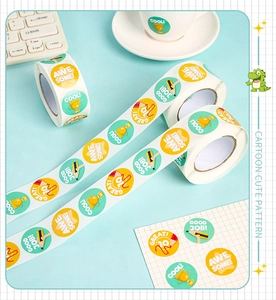 Macro view of assorted cartoon reward stickers on blue desk with trophy and star icons