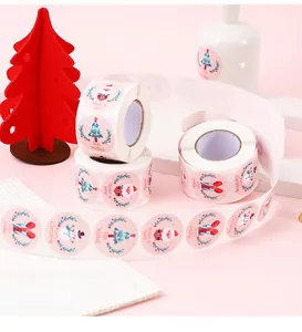 Roll of cartoon snowman and Christmas stickers featuring festive holiday illustrations