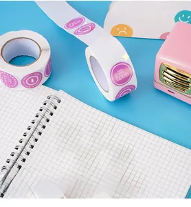 Close-up of pink round Made with Love stickers on a roll for Valentine gift wrapping