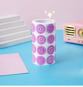 Detail of four purple round 'Made With Love' heart sticker rolls for gift packaging