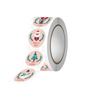 Roll of pink Christmas stickers featuring cartoon Santa and snowman for gift sealing