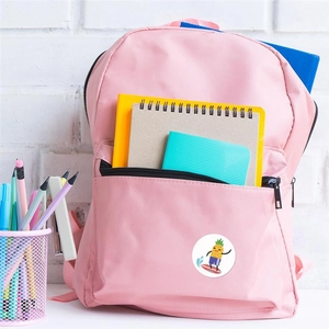 Pink school backpack decorated with a cartoon pineapple sticker showing storage capacity