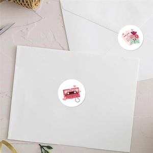 Close-up of Valentine's Day heart stickers on envelope with retro tape and flower motifs