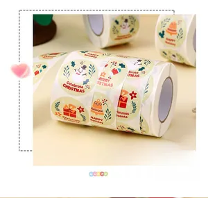 Close-up of circular Christmas gift labels featuring snowmen and holiday bells on a roll