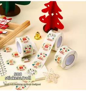 Detail of roll of 500 Merry Christmas labels with snowman and gift box patterns