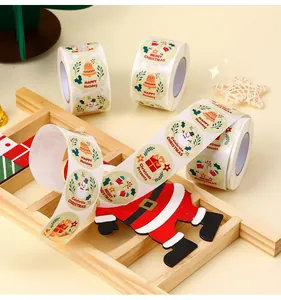 Close-up of assorted Christmas theme round stickers with snowman and bells on wood