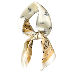 Elegant paisley pattern silk scarf in beige and yellow tied in a decorative knot