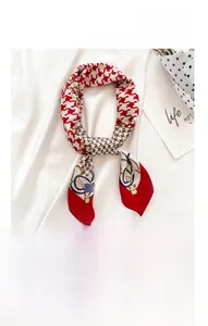 Detail of 70x70cm red houndstooth silk scarf with gold chains and panda motifs