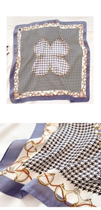 Detail view of houndstooth silk scarf with lavender and black horsebit chain patterns